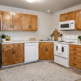 a kitchen with wooden cabinets